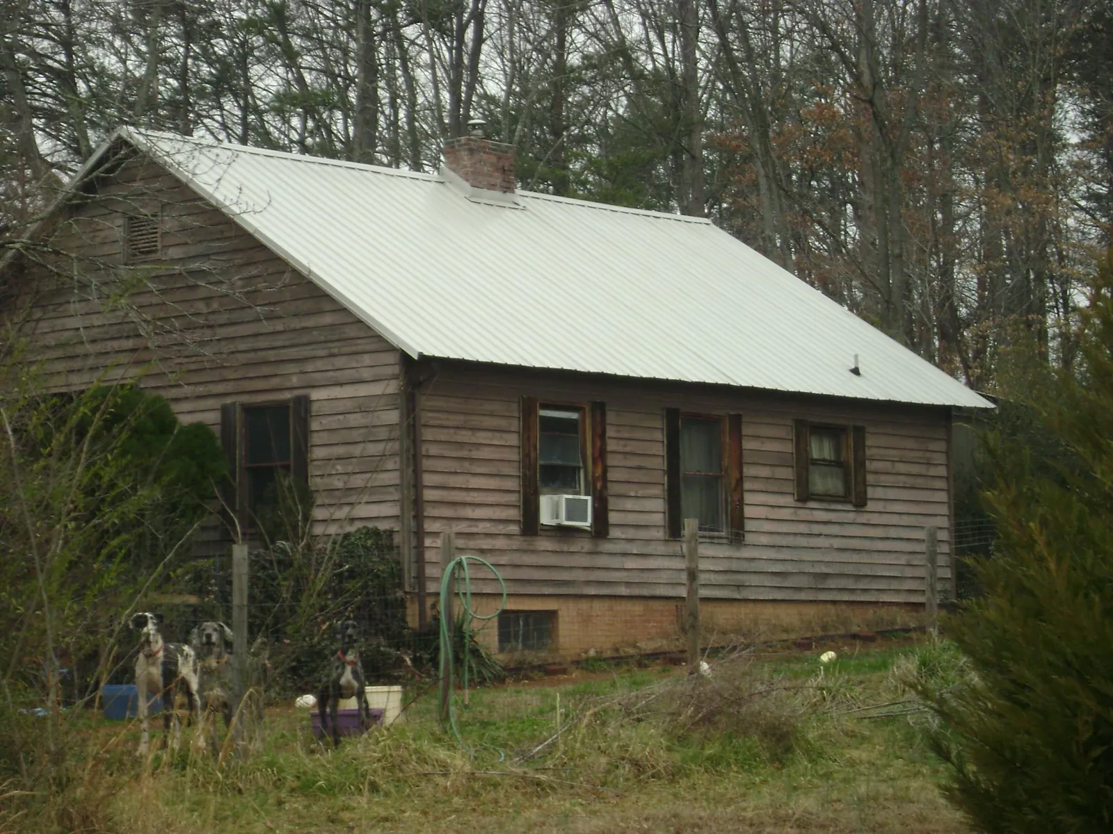 White metal roof on an old wood sided farmhouse, from a Metal Roof Installation job in North Apollo